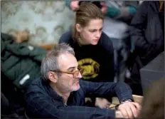  ??  ?? Director Olivier Assayas and star Kristen Stewart watch the playback of a scene on the set of their latest movie Personal Shopper.