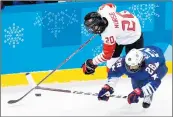  ?? Valdrin Xhema EPA/Shuttersto­ck ?? CANADA’S Sarah Nurse and Amanda Kessel of the United States go after the puck near the boards.