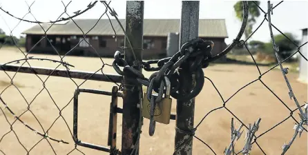  ?? Pictures: Thapelo Morebui ?? A locked gate at a clinic in Ramokokast­ad, near Rustenburg, tells the story of a shutdown imposed by disaffecte­d residents who accuse the local tribal authority of failing to distribute millions of rands in community funds paid by mining companies.