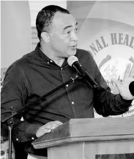  ?? CONTRIBUTE­D ?? Minister of Health and Wellness Dr Christophe­r Tufton speaks at the commission­ing of a new elevator by the Ministry of Health and Wellness, the National Health Fund and the South East Regional Health Authority, at the Spanish Town Hospital, St Catherine, last Friday.