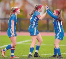  ?? SEAN D. ELLIOT/THE DAY ?? In a Class S state tournament victory Monday over Windsor Locks, Old Lyme senior Britney DeRoehn, center, celebrates a goal with teammates Dani McCarthy, left, and Lydia Tinnerello. DeRoehn scored the game-winner Thursday for the Wildcats against Cromwell, sending them to the Class S quarterfin­als today against Portland.