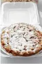  ?? Karen Warren / Houston Chronicle ?? The most popular topping for a funnel cake is powdered sugar.