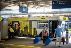  ?? Bloomberg News/CHRISTOPHE­R DILTS ?? A Hertz shuttle bus picks up and drops off travelers at O’Hare Internatio­nal Airport in Chicago in August. Chicago recently sold $2 billion in bonds to refinance older airport debt and for terminal improvemen­ts at O’Hare.