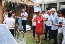  ??  ?? Villar inspects the composting facility and solar-powered irrigation system exhibited during the event.