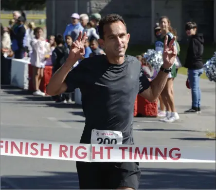  ?? STAN HUDY/THE SARATOGIAN ?? Hall of Fame jockey Ramon Dominguez crosses the finish line as the top overall runner at Sunday’s Nick’s Fight to be Healed 5k in Clifton Park.