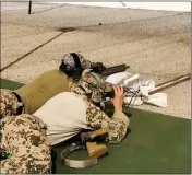  ?? Buy this photo at YumaSun.com PHOTO BY JAMES GILBERT/YUMA SUN ?? A PAIR OF GERMAN SPECIAL FORCES SOLDIERS (RIGHT) CALIBRATE THE SIGHTS of a HK416 A7 assault rifle prior to an operation test of the weapon held Friday at Yuma Proving Ground’s Graze Range.The German army has decided to get rid of the assault rifle its...