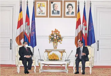  ?? AFP ?? This handout from the National Television of Cambodia (TVK) taken and released on Dec 7 shows Myanmar’s Foreign Minister Wunna Maung Lwin, left, listening to Cambodia’s Prime Minister Hun Sen at the Peace Palace in Phnom Penh.