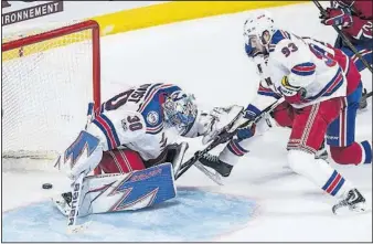  ?? [PAUL CHIASSON/THE CANADIAN PRESS VIA AP] ?? Montreal’s Alexander Radulov scores past New York Rangers goaltender Henrik Lundqvist, left, as Mika Zibanejad looks on during overtime in Game 2 of a first-round playoff series Friday in Montreal.