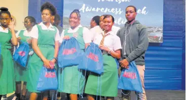  ??  ?? Manchester High School students showing off the gifts they got from the Jamaica Tourist Board during the Tourism Career Expo concert.