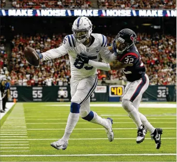  ?? TIM WARNER / GETTY IMAGES ?? Colts tight end Eric Ebron runs in a reception for a TD before Texans safety Tyrann Mathieu can bring him down in the first quarter Saturday. The Colts won 21-7 and advance to play Kansas City next weekend.