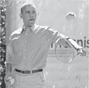  ??  ?? President Barack Obama plays tennis during the annual White House Easter Egg Roll on April 21, 2014, on the tennis court on the South Lawn. AP