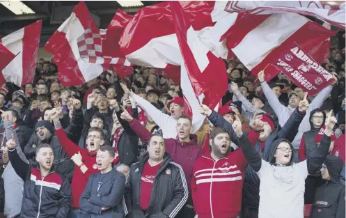  ??  ?? 0 Aberdeen fans get behind their team at Pittodrie but the 300 supporters who attend Saturday’s match will have to show more restraint.