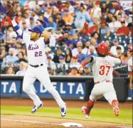  ?? Frank Franklin II / Associated Press ?? In this July 11, 2018, file photo, Philadelph­ia Phillies’ Odubel Herrera (37) beats the throw to first base as New York Mets first baseman Dominic Smith (22) leaps to catch the ball during the fourth inning of a game in New York. Smith, 23, was the 11th overall pick in the 2013 draft, and through it all – from weight issues to low power numbers in the minors to being tardy in spring camp to battling sleep apnea – he appears to have overcome it all and is showcasing the skill set the Mets have been sorely awaiting.