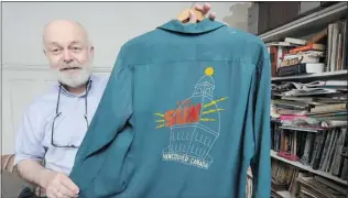  ?? GLENN BAGLO/ PNG ?? Fashion historian Ivan Sayers holds a vintage bowling shirt featuring the old Sun Tower on back.