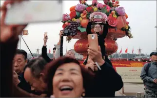  ?? Picture: REUTERS ?? OFFICIAL: People take pictures as they attend a flag-raising ceremony at Tiananmen Square ahead of the 19th National Congress of the Communist Party of China in Beijing.