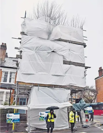  ?? ?? A 120-year-old plane tree in Haringey, North London, is protected by scaffoldin­g while the council awaits the go-ahead to fell it