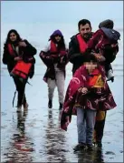  ?? ?? Migrants coming ashore at Dungeness