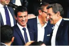  ?? AP ?? Eyeing another term French Prime Minister Manuel Valls (left) shares a light moment with former French President, Nicolas Sarkozy before the quarter final first leg Champions League match between Paris Saint Germain and Barcelona on Wednesday.