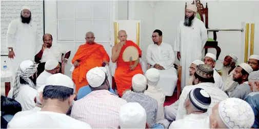  ??  ?? Buddhist monks addressing the congregati­on at Masjid Bilal Mosque on Friday. Pic by Priyantha Wickramaar­achchi