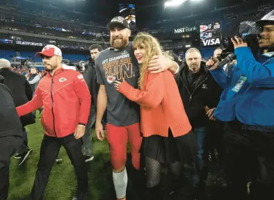  ?? JULIO CORTEZ/AP ?? Kansas City Chiefs tight end Travis Kelce walks with singer Taylor Swift after the AFC Championsh­ip on Sunday in Baltimore.
