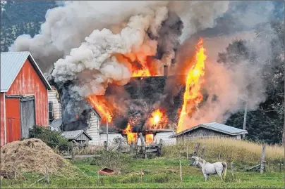  ?? PAUL GAUTHIER/SPECIAL TO THE GUARDIAN ?? A fire engulfs a farmhouse on Wynn Road in Elmwood Sunday.