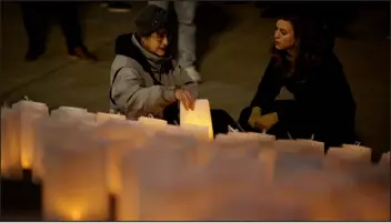  ?? HYOUNG CHANG — THE DENVER POST ?? Karen Underwood places a candle for son Kevin Blue Underwood, 33, during the annual Homeless Person’s Memorial Vigil in front of the Denver City and County Building in Denver on Dec. 21. Underwood lost her son on June 13.