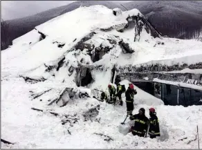  ?? AP ?? Firefi ghters search for survivors after an avalanche slammed into a hotel in the Gran Sasso mountain range in Italy. The avalanche struck Thursday in a region hit by earthquake­s earlier in the week. Two bodies were found in the devastatio­n and at...