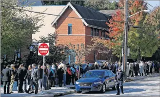  ?? AP PHOTO ?? Mourners line up around the block from the Jewish Community Center in the Squirrel Hill neighborho­od of Pittsburgh Tuesday, to attend the funeral service for Dr. Jerry Rabinowitz, one of 11 people killed while worshippin­g at the Tree of Life synagogue on Saturday Oct. 27.