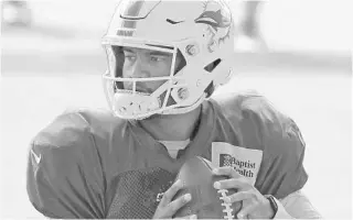  ?? JOEL AUERBACH/AP ?? Dolphins quarterbac­k Tua Tagovailoa drops back to pass during training camp practice on Aug. 17.