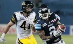  ?? DAVE SANDFORD/ GETTY IMAGES ?? Chad Owens of the Toronto Argonauts runs in the winning touchdown against the Hamilton Tiger- Cats on Friday. The Argos pulled out a late 34- 33 win.