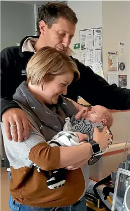  ??  ?? Wairarapa resident Rebecca O’Neale with her husband Gavin, holding baby Luke the day he was discharged from Wellington Hospital.