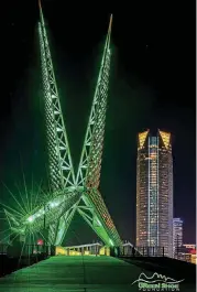  ?? [PHOTO PROVIDED] ?? The Skydance Bridge, which spans Interstate 40 south of downtown Oklahoma City, will glow green on Wednesday to mark World Mental Health Day.