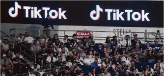  ?? Frank Franklin Ii/associated Press ?? Fans sit last year under a Tiktok ad at a baseball game at Yankee Stadium. A poll shows U.S. adults split about whether the app should be banned.