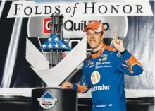  ?? THE ASSOCIATED PRESS ?? Brad Keselowski poses with the trophy in victory lane after winning a NASCAR Monster Cup series auto race in Atlanta on Sunday.