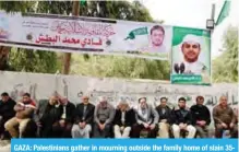  ?? — AFP ?? GAZA: Palestinia­ns gather in mourning outside the family home of slain 35year-old professor Fadi Mohammad Al-Batsh in Jabaliya yesterday.