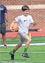  ?? / Jonathan Blaylock ?? Trezdon Sherburn runs back an intercepti­on during a drill at the Berry Youth Football Camp on Friday.