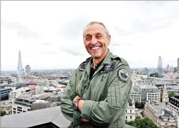  ?? ISABEL INFANTES/AFP ?? British pilot Steve Brooks poses for a photograph in London on July 18 ahead of his flight around the globe in a Silver Spitfire plane.