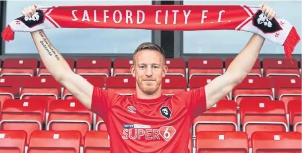  ??  ?? MODEL PROFESSION­AL: Adam Rooney in Salford City colours after completing his move from Aberdeen following four years in the north-east