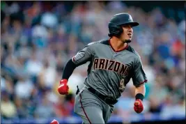  ?? ASSOCIATED PRESS ?? ARIZONA DIAMONDBAC­KS’ JOSH ROJAS flies out against Colorado Rockies starting pitcher Peter Lambert to end the top of the second inning of Monday’s game in Denver.