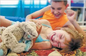  ??  ?? Lexi plays in June with her cousin Jordan Swinney, 11, in the playroom of the Schneiders’ home in Bosque Farms.