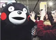  ?? JIANG HUAIWEI / FOR CHINA DAILY ?? Visitors take photos of Kumamon, a popular mascot from Japan, at the Taipei Internatio­nal Comics and Animation Festival on Thursday. The five-day event has products from 450 exhibitors.