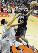  ?? David J. Phillip ?? The Associated Press Rockets guard James Harden soars to the basket against Timberwolv­es center Karl-anthony Towns in Houston’s 104101 win Sunday at Toyota Center.