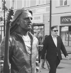  ??  ?? Saakashvil­i walks past a monument to Polish musician Tadeusz Nalepa in central Rzeszow, Poland. — Reuters photo