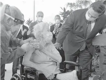  ?? LAVANDIER/AP ?? Florida Gov. Ron DeSantis asks Vera Leip, 88, how she feels after a nurse administer­s the Pfizer COVID-19 vaccine at John Knox Village in Pompano Beach Dec. 16.MARTA