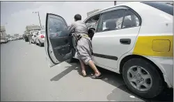  ?? — THE ASSOCIATED PRESS FILES ?? A Yemeni man pushes his car in a gas station lineup amid fuel shortages in Sanaa, Yemen.