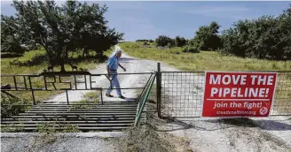  ?? Associated Press file photo ?? A property owner near Stonewall shows where the controvers­ial Kinder Morgan pipeline through the Texas Hill Country is slated to go. The pipeline is the focus of another lawsuit.