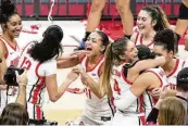  ?? SUE OGROCKI / ASSOCIATED PRESS ?? Ohio State guard Jacy Sheldon (4) celebrates with teammates after the team’s win over Michigan to claim the regular-season Big Ten title Wednesday in Columbus. Sheldon led the Buckeyes with 22 points.