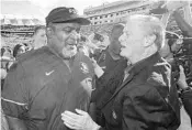  ?? MARK WALLHEISER/ASSOCIATED PRESS ?? FSU interim head coach Odell Haggins talks with Florida State president John Thrasher after Saturday’s game.