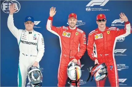  ??  ?? TOP TRIO: Pole winner Sebastian Vettel is flanked by Ferrari teammate Kimi Raikkonen, right, and Valtteri Bottas of Mercedes.