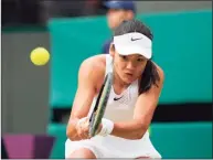  ?? Alberto Pezzali / Associated Press ?? Emma Raducanu plays a return to Sorana Cirstea during the third round at Wimbledon on Saturday.